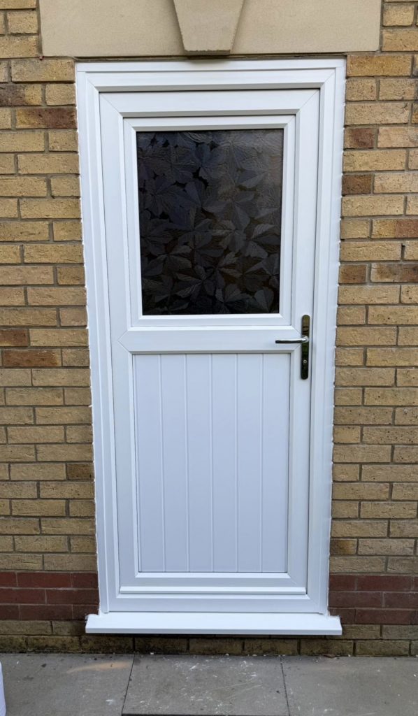 Secure white uPVC door with decorative glass – installed in Swansea by Lion Guard