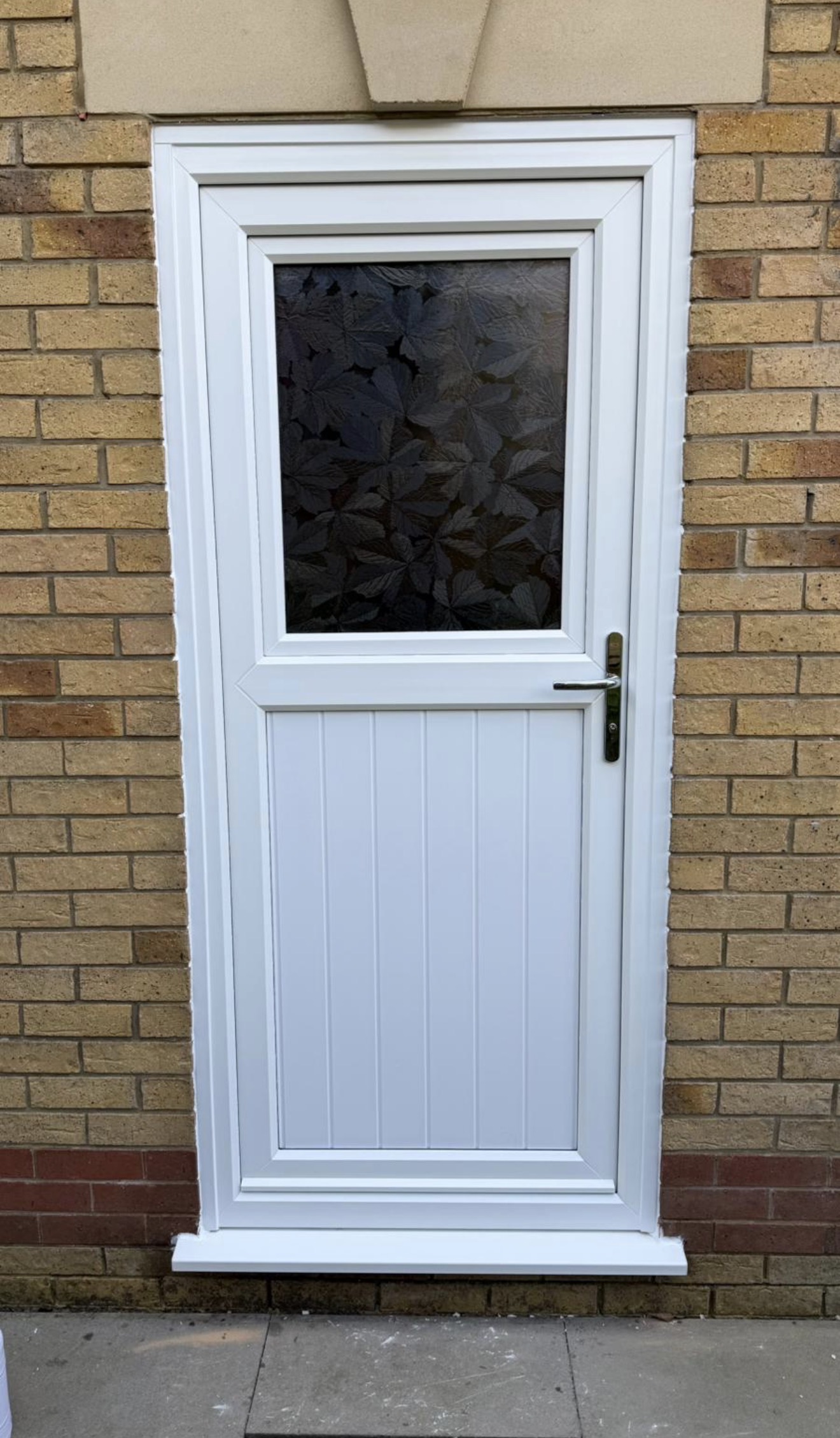Secure white uPVC door with decorative glass – installed in Swansea by Lion Guard